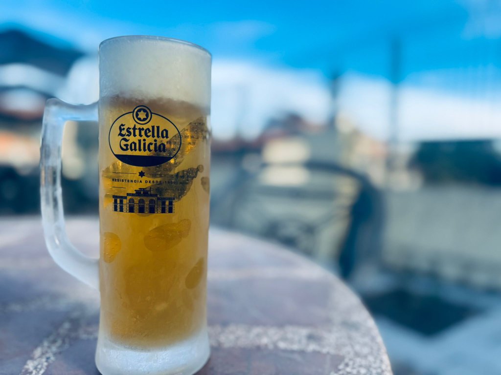 Cold Estrella Galicia beer on a terrace at the end of a motorcycle touring day in Spain
