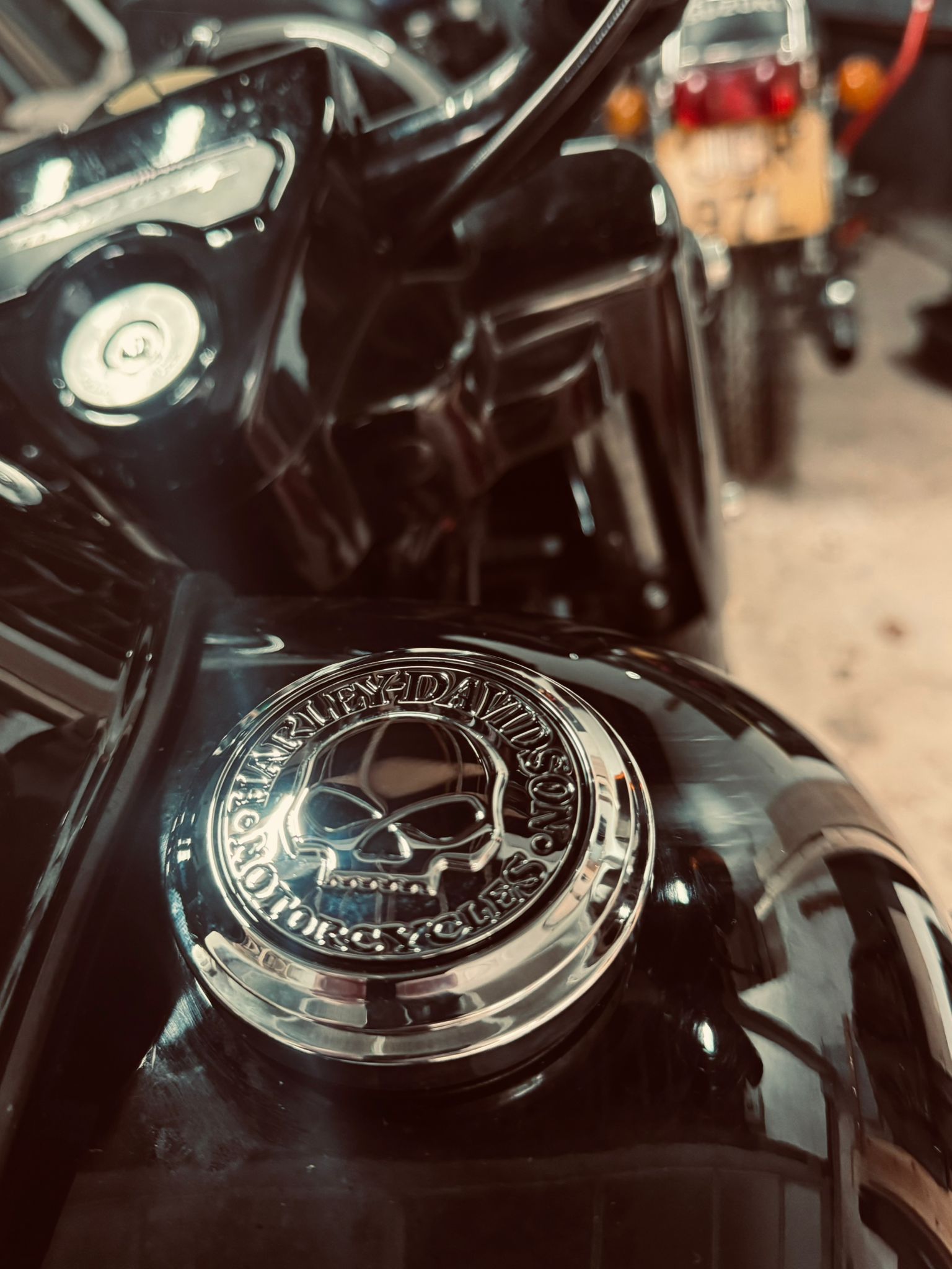 Close-up of Harley Davidson skull fuel cap on a freshly cleaned black tank