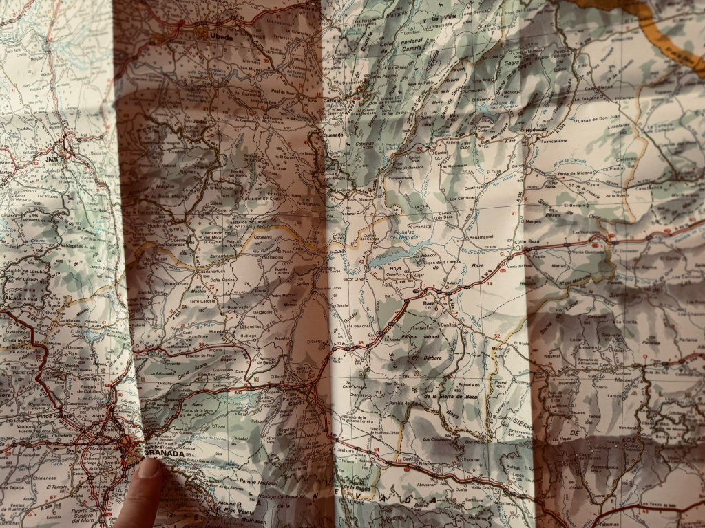 Paper road map of Spain spread out during a motorcycle touring trip