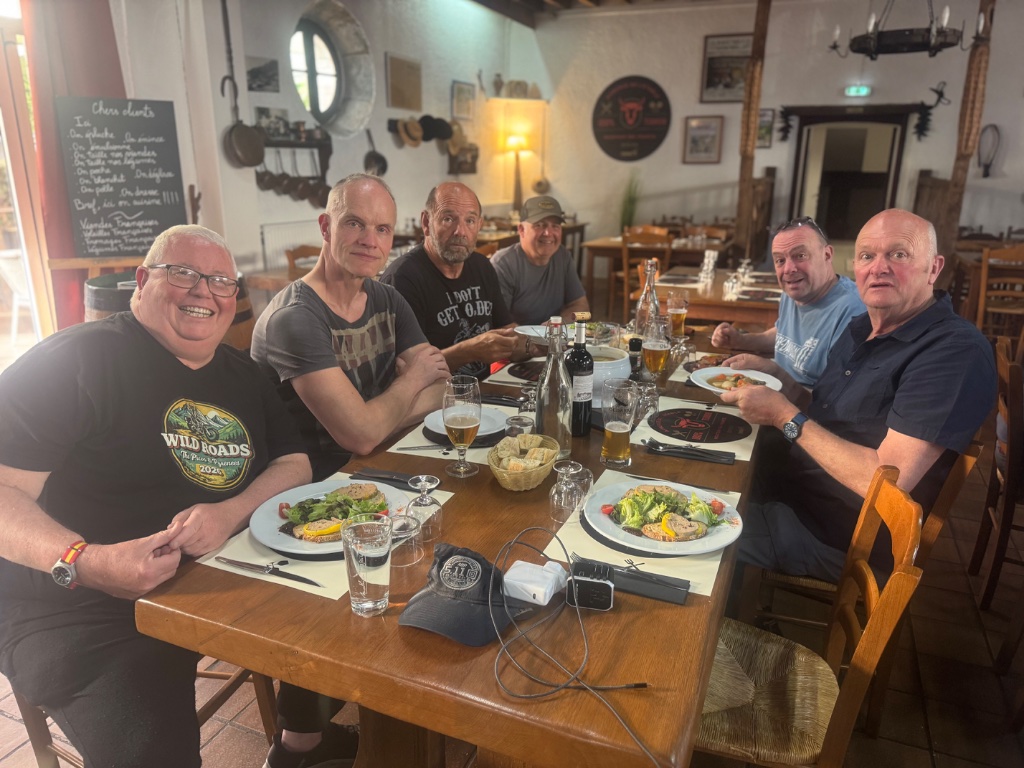 Wild Roads group of six at dinner table — Logis Hôtel l'Auberge de l'Etable Montory France — Picos & Pyrenees May 2026