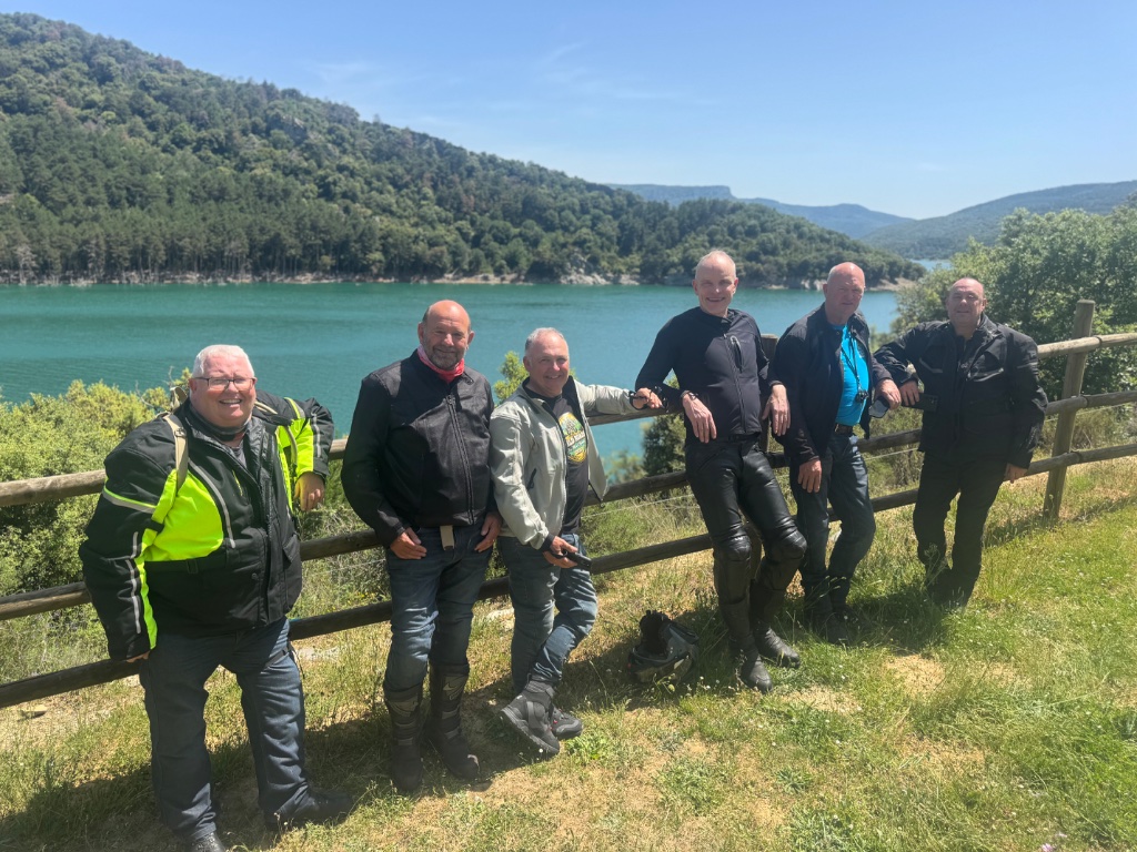 Wild Roads group of six at turquoise lake viewpoint — Basque Country Spain — Picos & Pyrenees May 2026