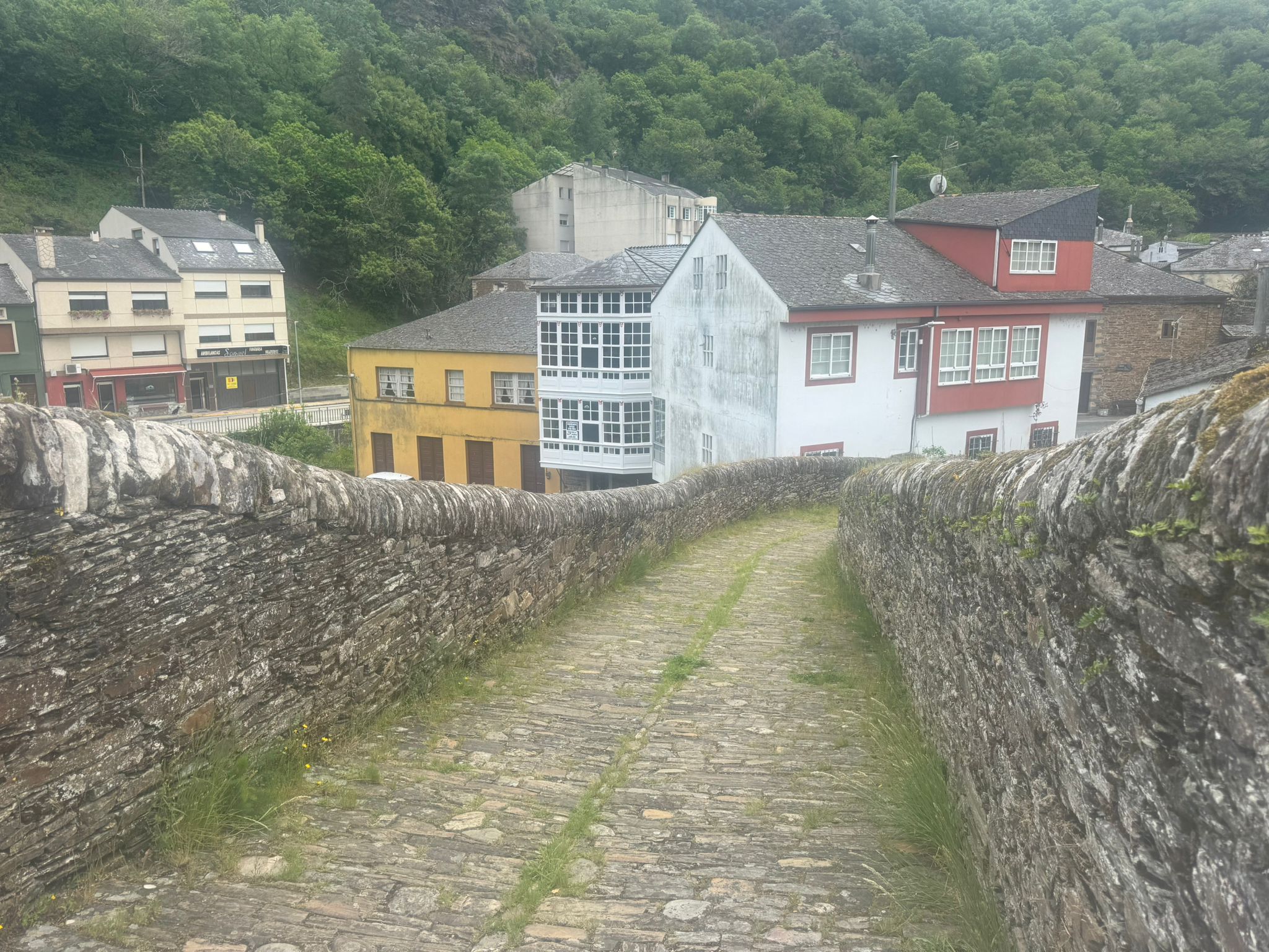 Ancient stone bridge and cobblestone path Galicia — Wild Roads Motorcycle Tour Spain