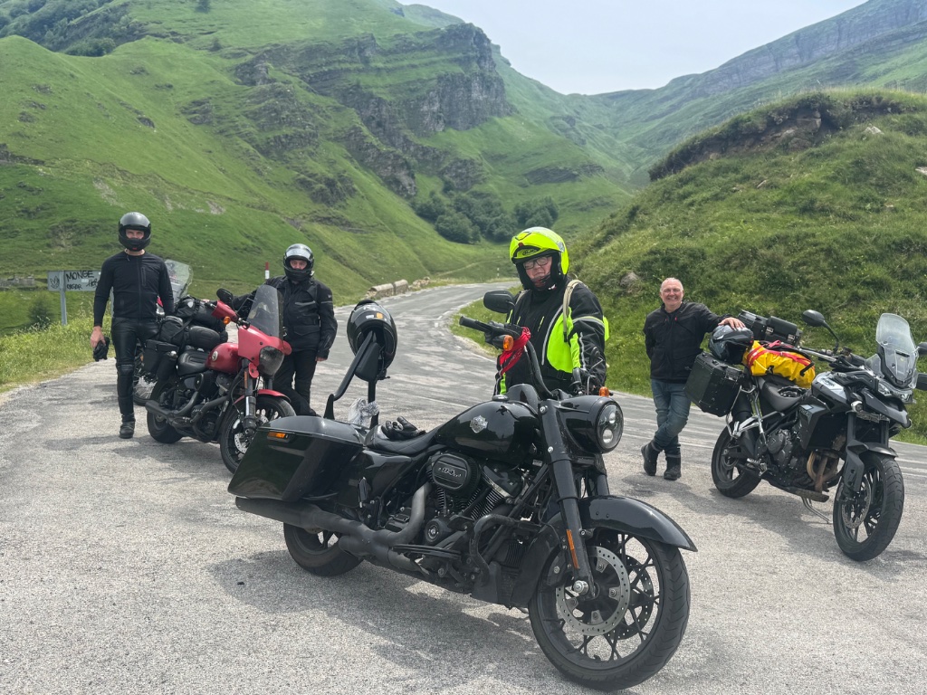 Wild Roads group photo at Monge col Pyrenees four bikes — Picos & Pyrenees May 2026