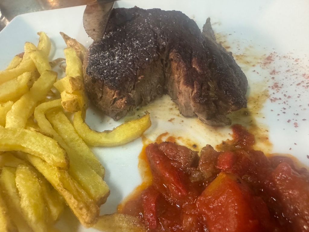 Grilled steak with frites and tomato sauce — Logis Hôtel l'Auberge de l'Etable Montory France — Wild Roads dinner May 2026