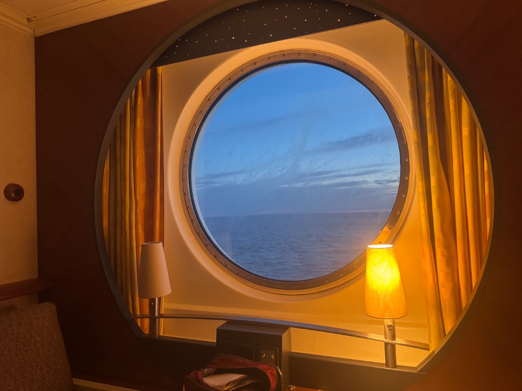 Ferry cabin porthole window Atlantic Ocean evening Bay of Biscay homeward crossing — Picos & Pyrenees May 2026