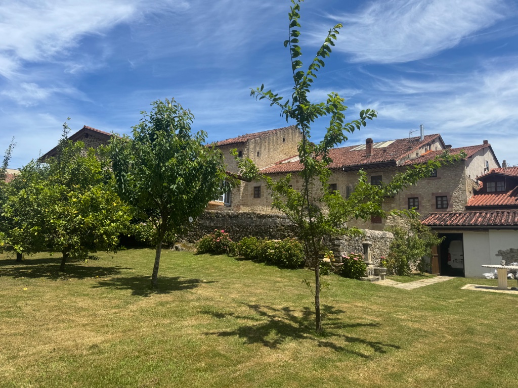 Parador de Gil Blas walled garden Santillana del Mar morning sunshine — Picos & Pyrenees May 2026