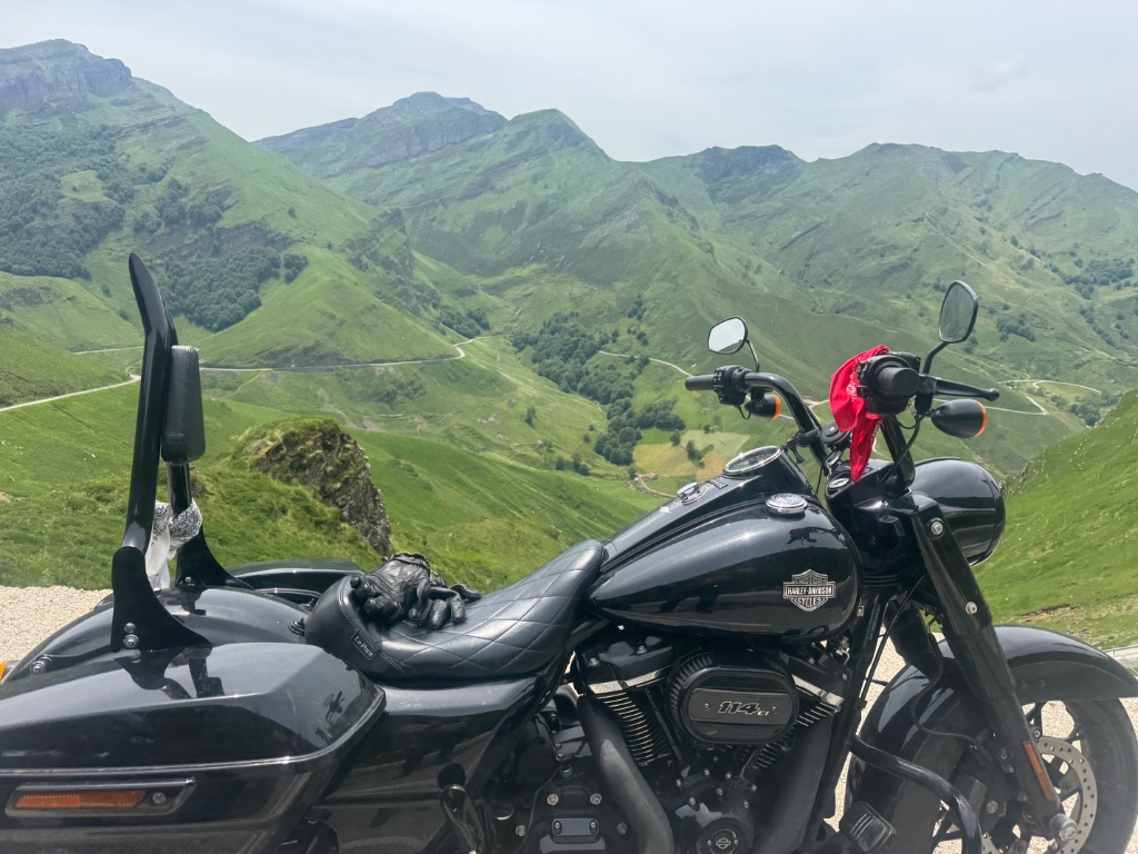 Harley Davidson Road King 114 parked at Pyrenean mountain viewpoint winding road — Picos & Pyrenees May 2026