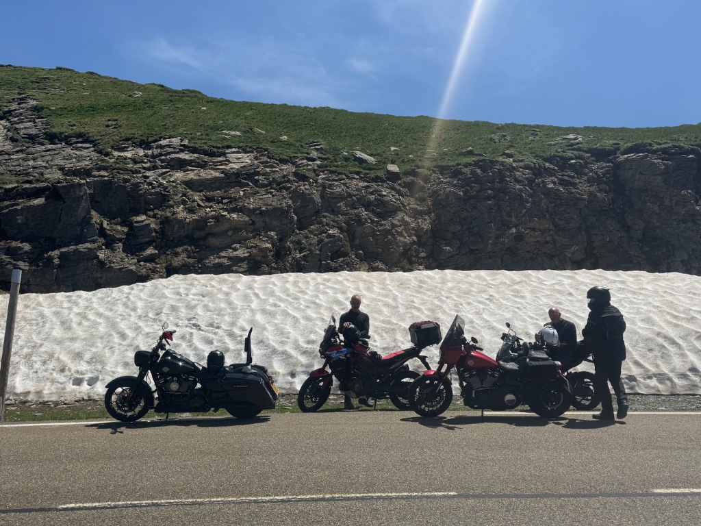 Wild Roads bikes parked in front of snow bank at high altitude — French Pyrenees May 2026