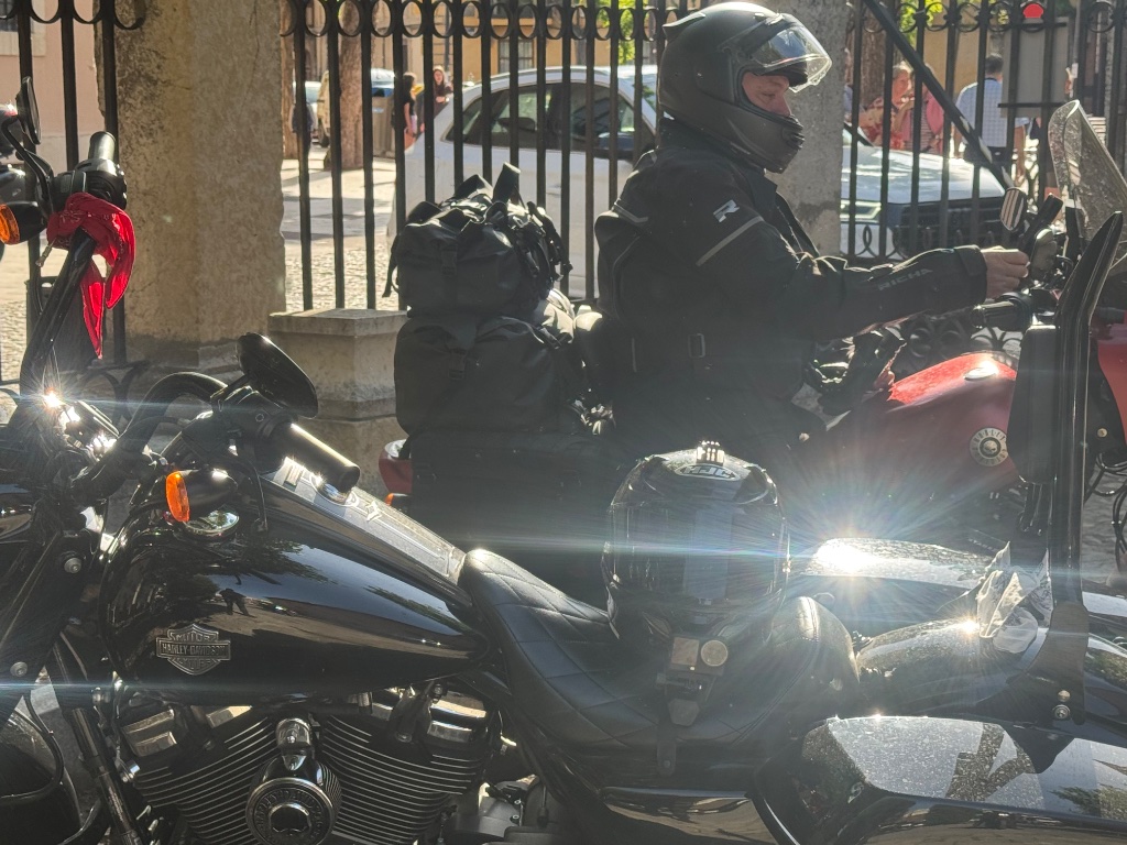 Harley-Davidson touring bike alongside adventure bikes at León departure — Wild Roads Picos & Pyrenees May 2026