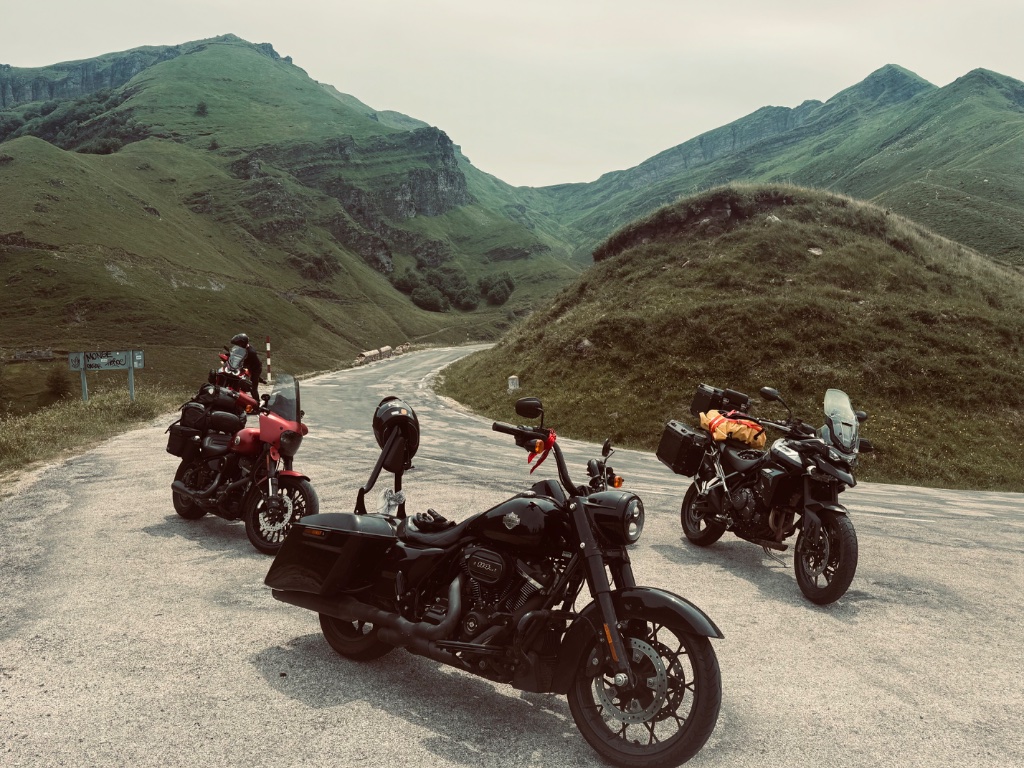 Three bikes Harley Street Bob Road King Triumph Tiger at Pyrenean col — Picos & Pyrenees May 2026