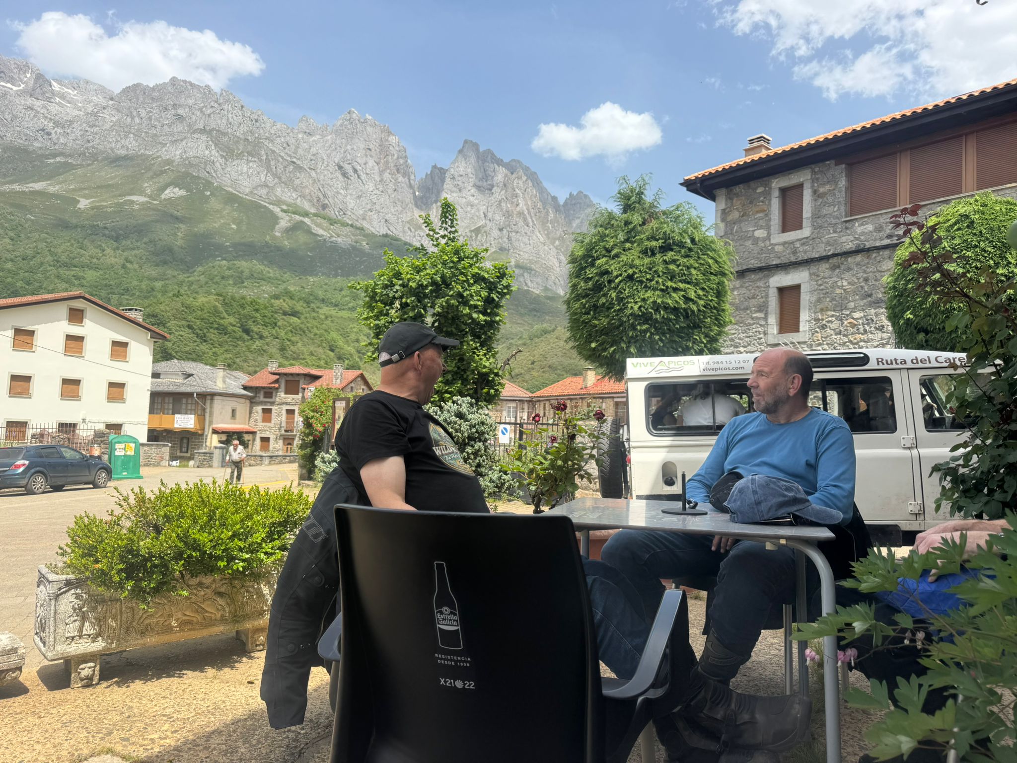 Riders enjoying coffee in the shadow of the Picos de Europa limestone peaks