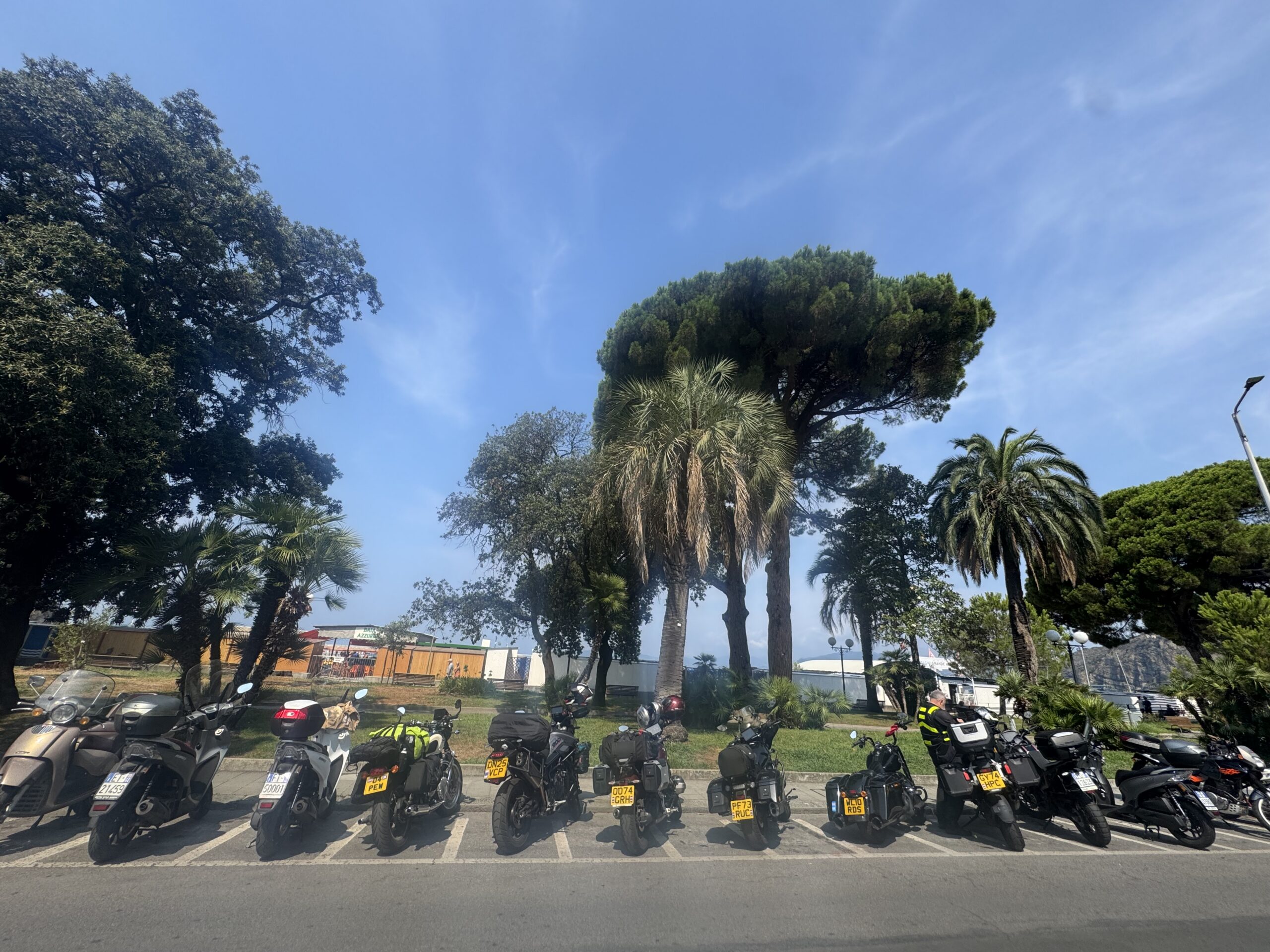 Motorcycles lined up early morning in Sestri Levante heat — Twisties &amp; Tuscan Sun July 2026