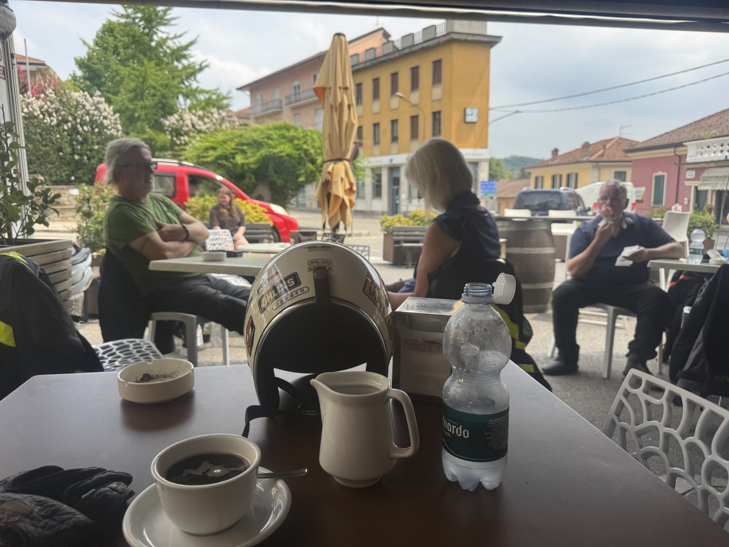 Motorcycles parked in Piazza Roma Gavi during midday pit stop — Twisties &amp; Tuscan Sun July 2026