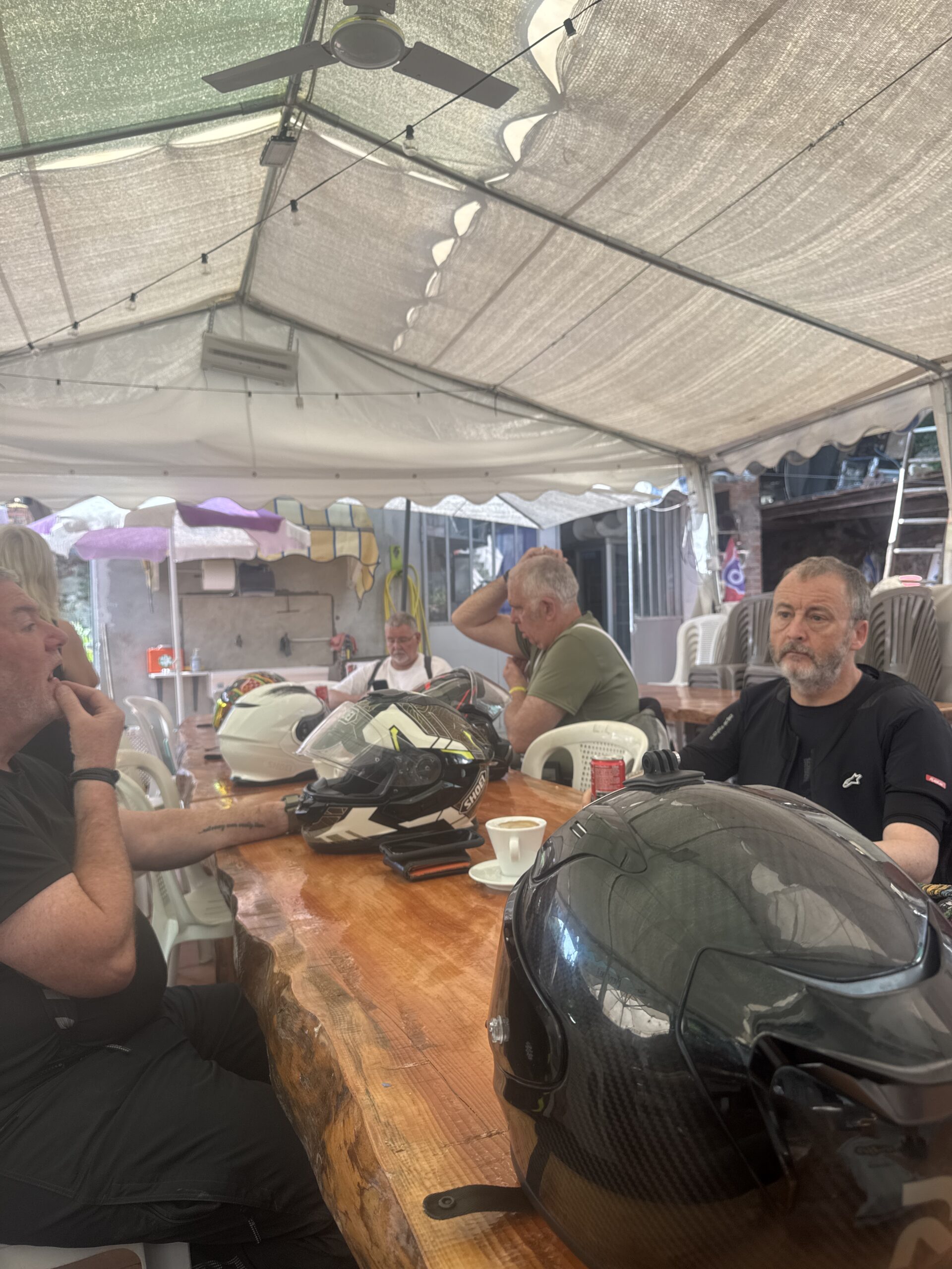 Riders enjoying hot espresso and relaxed conversation during the morning stop in Regione Montiglie