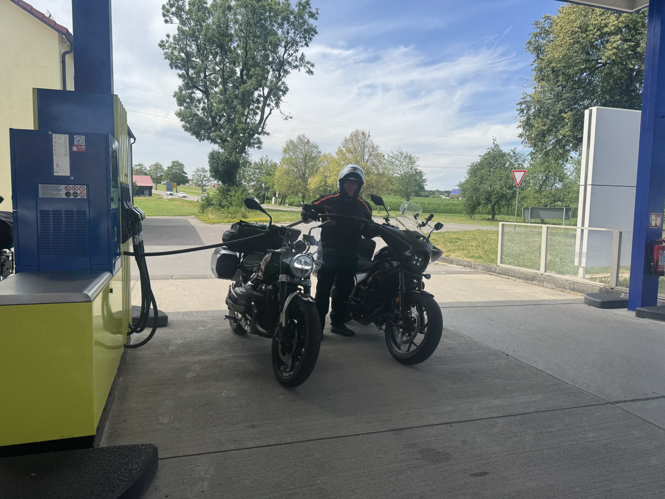 Bikes parked with towering mountain peaks in the background at Garmisch — Twisties & Tuscan Sun July 2026
