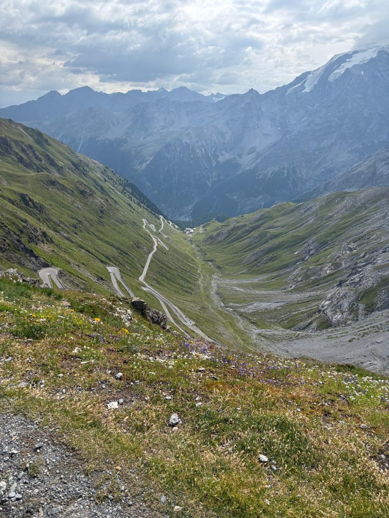 Riders at Passo Pordoi summit with mountain backdrop — Twisties &amp; Tuscan Sun July 2026