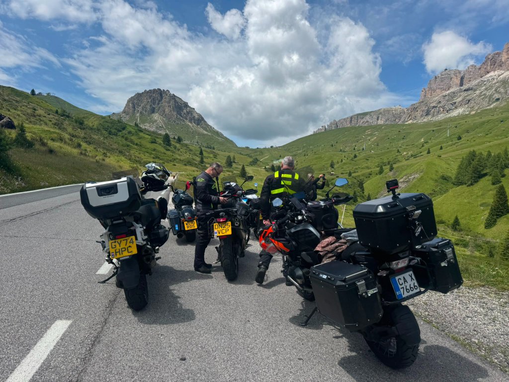 Motorcycles parked in Corvara in Badia before ascending Passo Gardena — Twisties &amp; Tuscan Sun July 2026