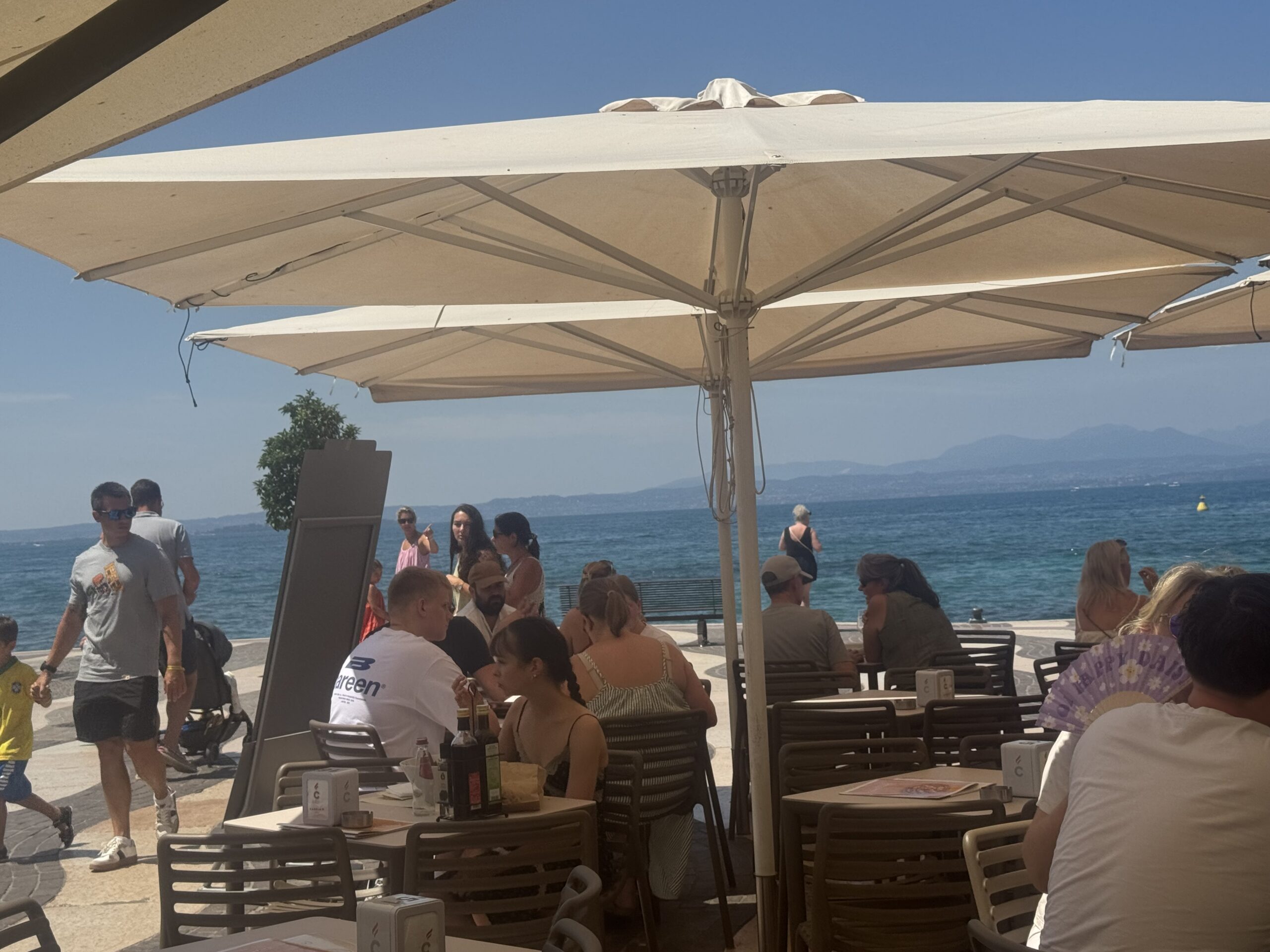 Scenic harbour promenade and medieval architecture in Lazise on Lake Garda