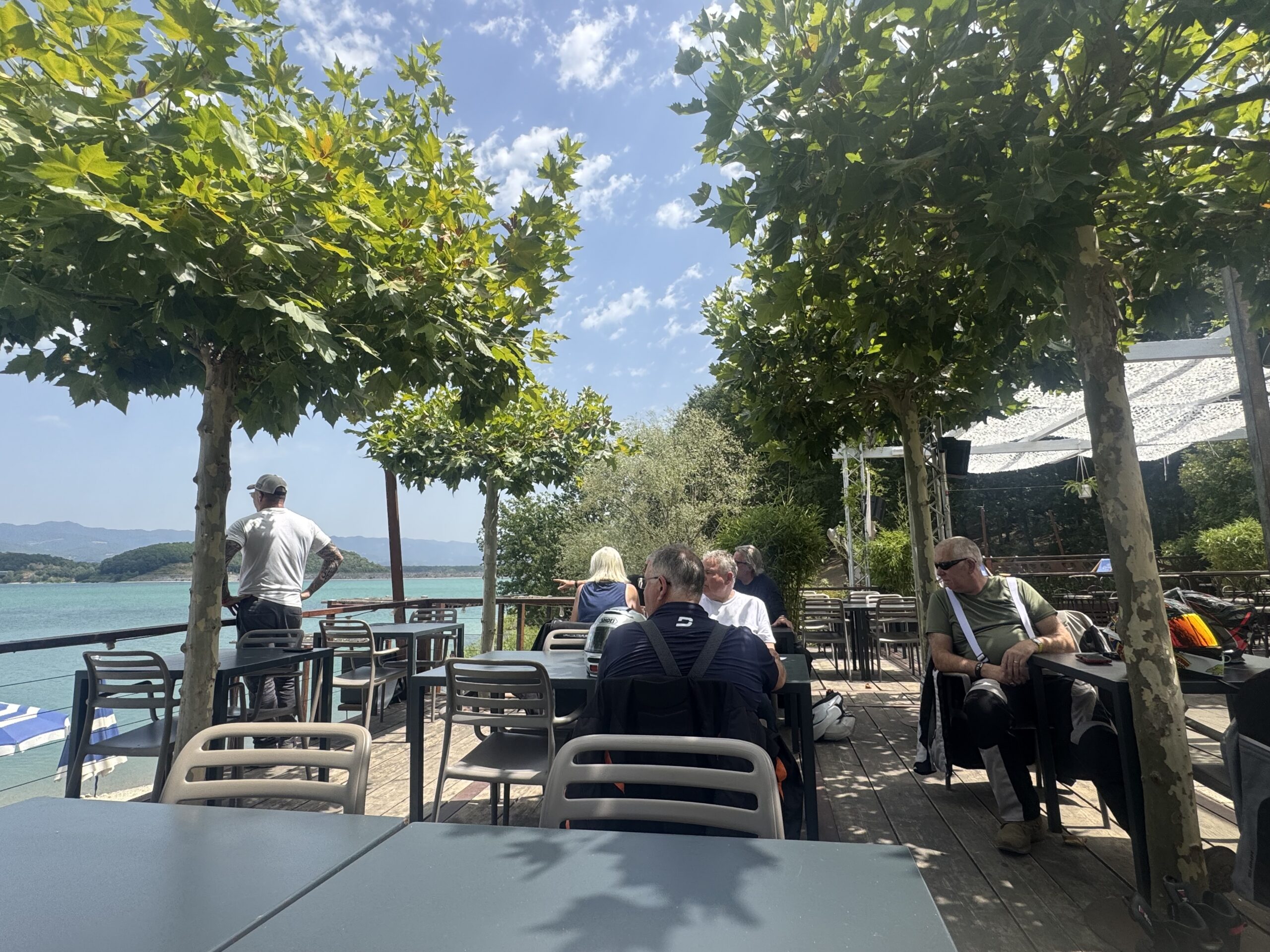Group enjoying a relaxed lakeside coffee break near Via Gastone Nencini at Lago di Bilancino