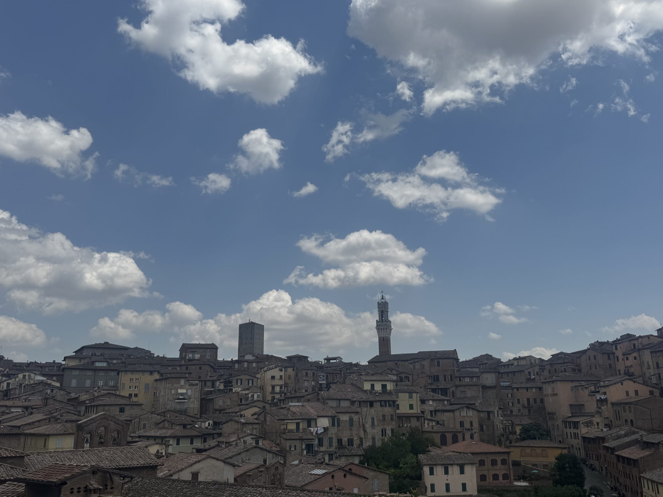 Motorcycles parked near Siena's historic city walls
