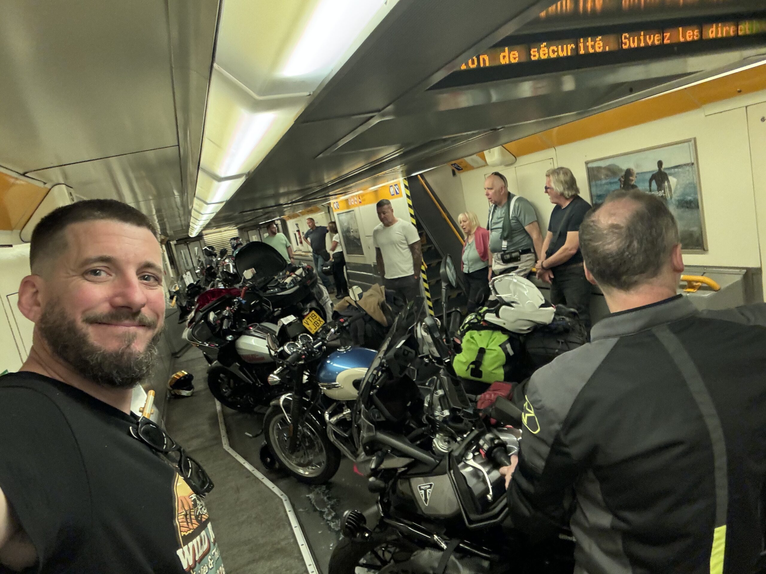 Joshua James and Wild Roads riders with their motorbikes on the Eurotunnel train — riding to the Black Forest from the UK — Wild Roads Motorcycle Tours