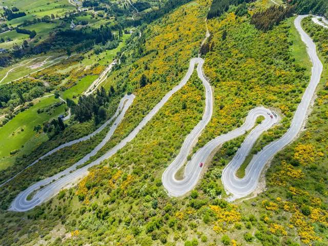 Crown Range switchbacks near Queenstown — Road to Aotearoa motorcycle expedition — Wild Roads
