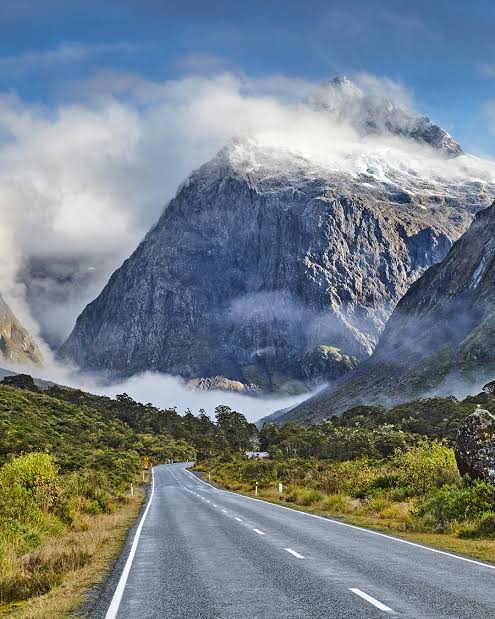 Cloud-wrapped peak above the road into Milford Sound, Fiordland, New Zealand — Road To Aotearoa Trailblazer Expedition — Wild Roads